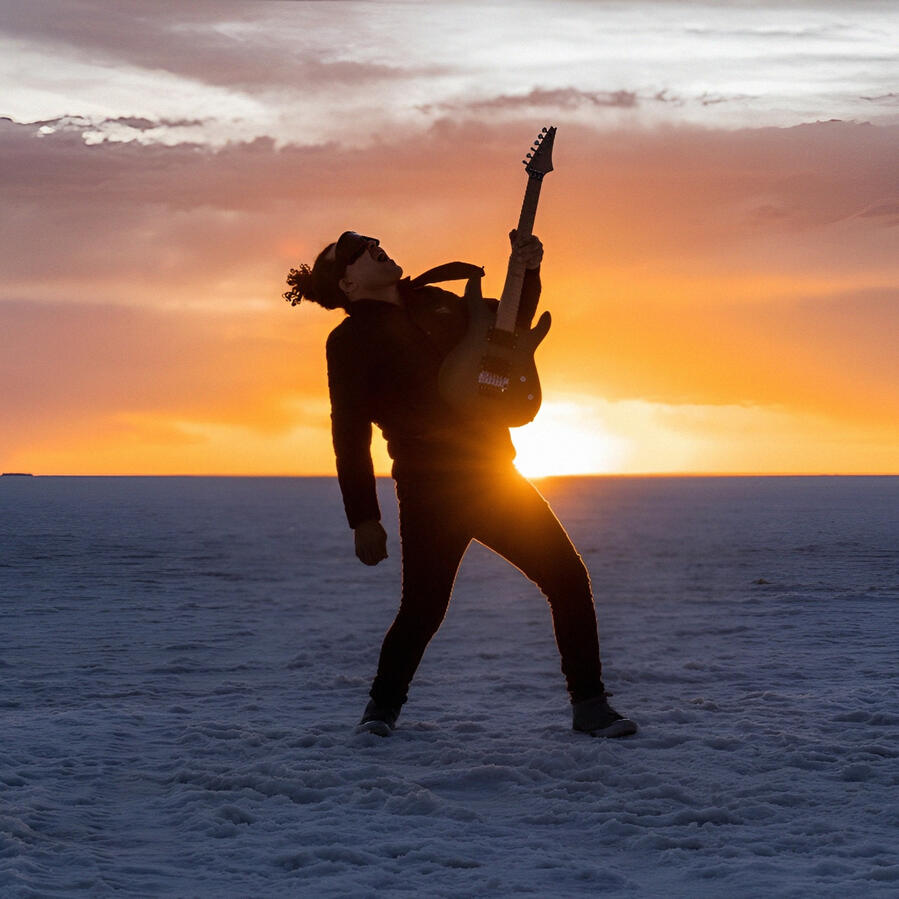 Sunset at the Salar de Uyuni Everton Vidal Azevedo silhouette with guitar at sunset on the Salar de Uyuni. Photo by Marvin Montes.